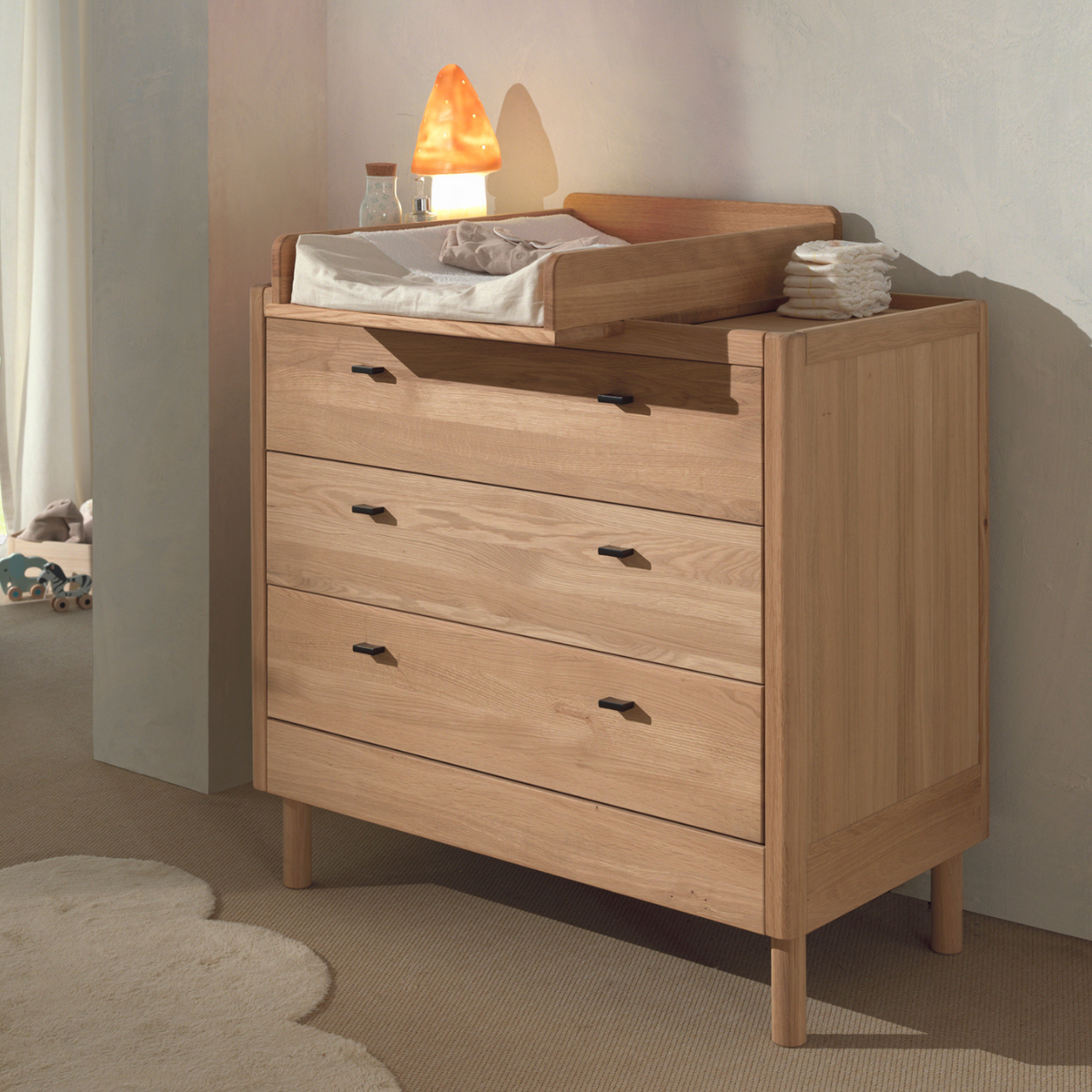 Oak 3 drawer chest with removable baby changing top changing in a nursery setting