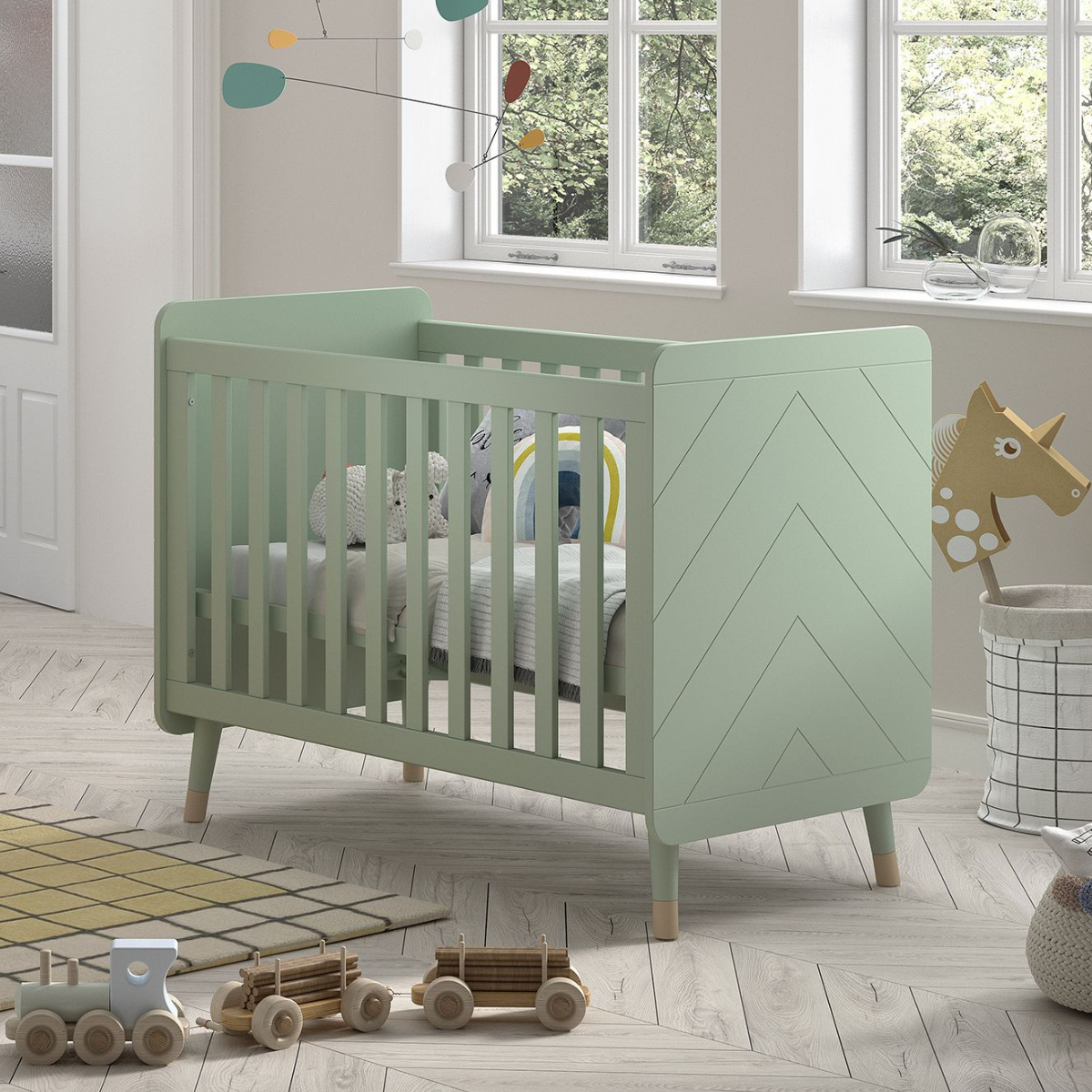 VIPACK JAXX BILLY olive green & gold 120x60cm cot with mattress and cost bedding in an infants nursery bedroom. Solid olive green cot ends with modern engraved detailing. Cot has gold feet gold legs. olive green & gold modern infant baby cot