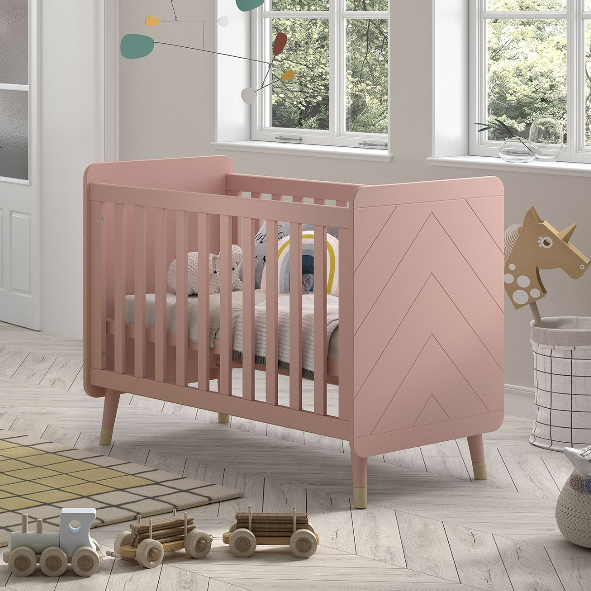 VIPACK JAXX BILLY pink & gold 120x60cm cot with mattress and cost bedding in an infants nursery bedroom. Solid pink cot ends with modern engraved detailing. Cot has gold feet gold legs. pink & gold modern infant baby cot