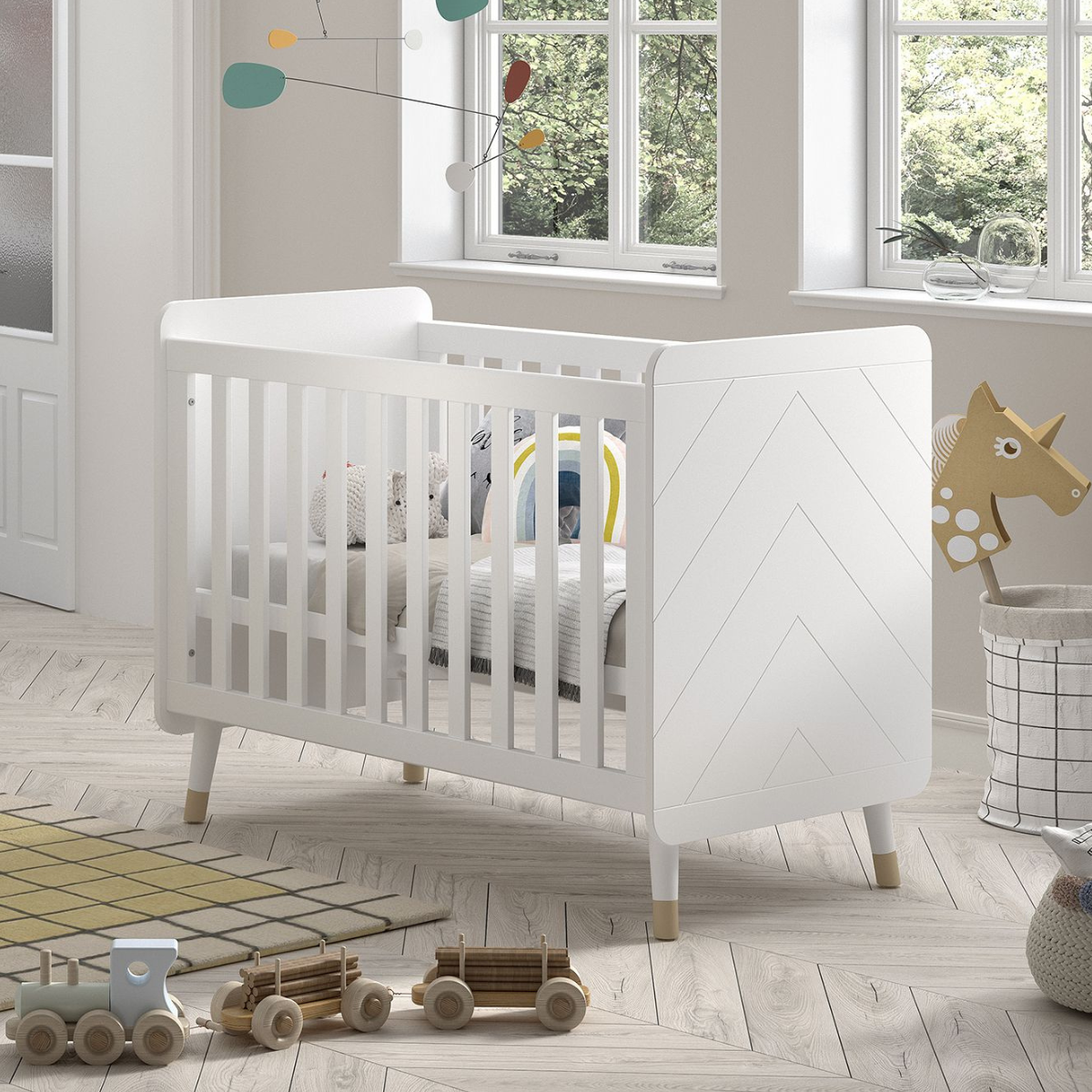 VIPACK JAXX BILLY White & gold 120x60cm cot with mattress and cost bedding in an infants nursery bedroom. Solid white cot ends with modern engraved detailing. Cot has gold feet gold legs. White & gold modern infant baby cot