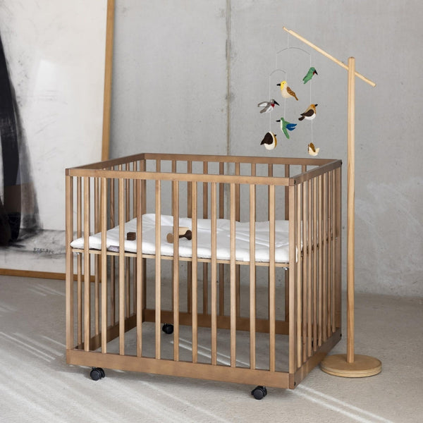 wooden baby playpen in home with modern neutral decor