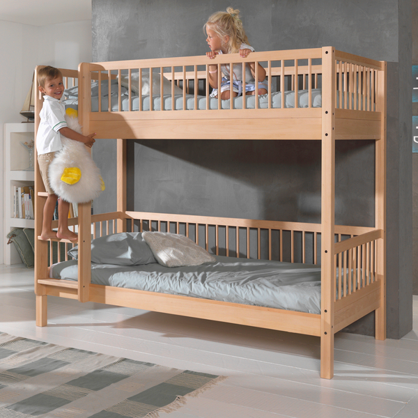 two children on a natural wood bunk bed in a light modern bedroom