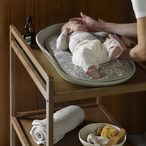 baby on a baby changing mat with soft inlay cushion on modern changing table