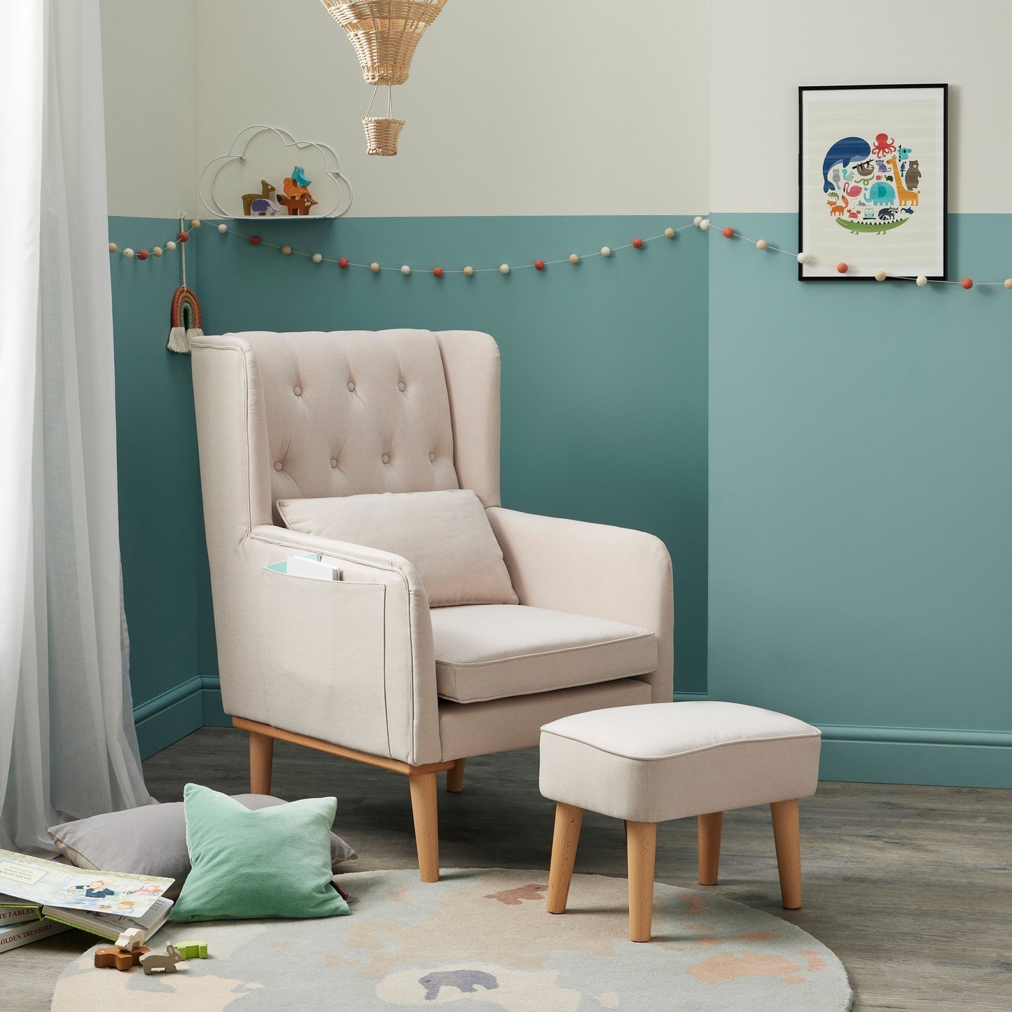 Babymore Lux nursing chair and footstool in cream fabric in nursery with teal and grey wall. 