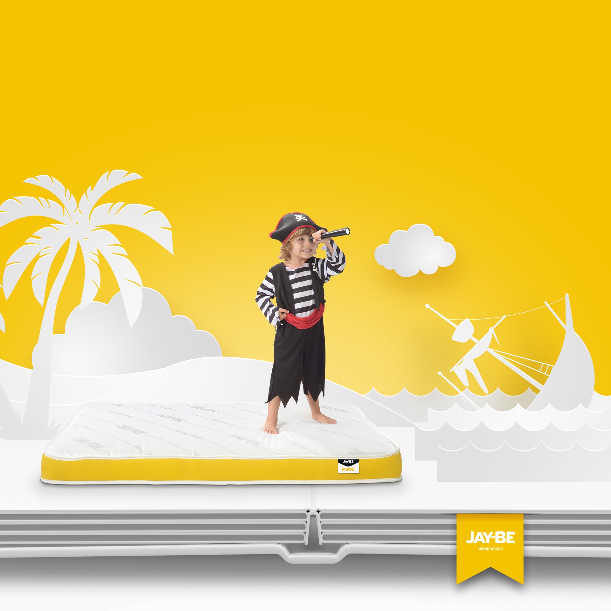 child in pirate costume standing on Jay-Be 140x70cm anti allergy pocket spring toddler mattress