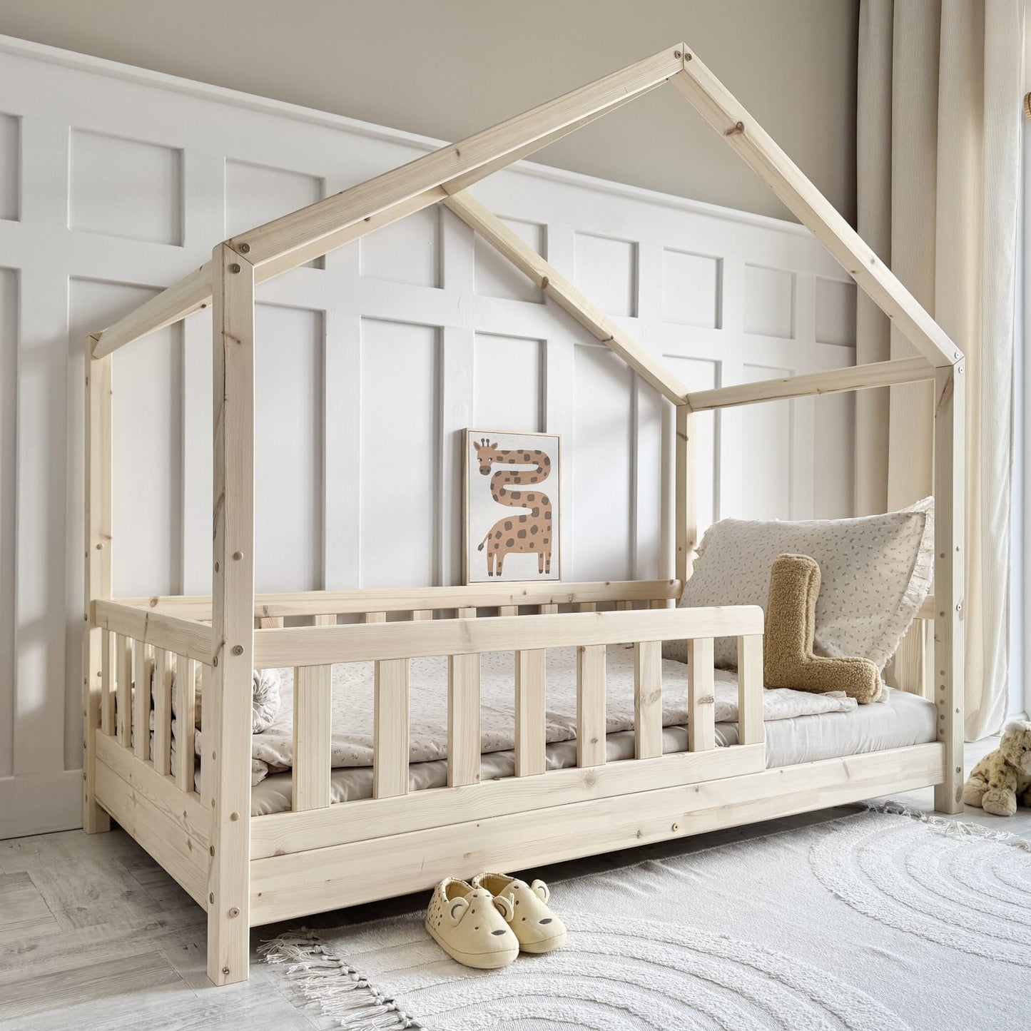 natural pine wood house shaped toddler bed with safety rail in scandi bedroom