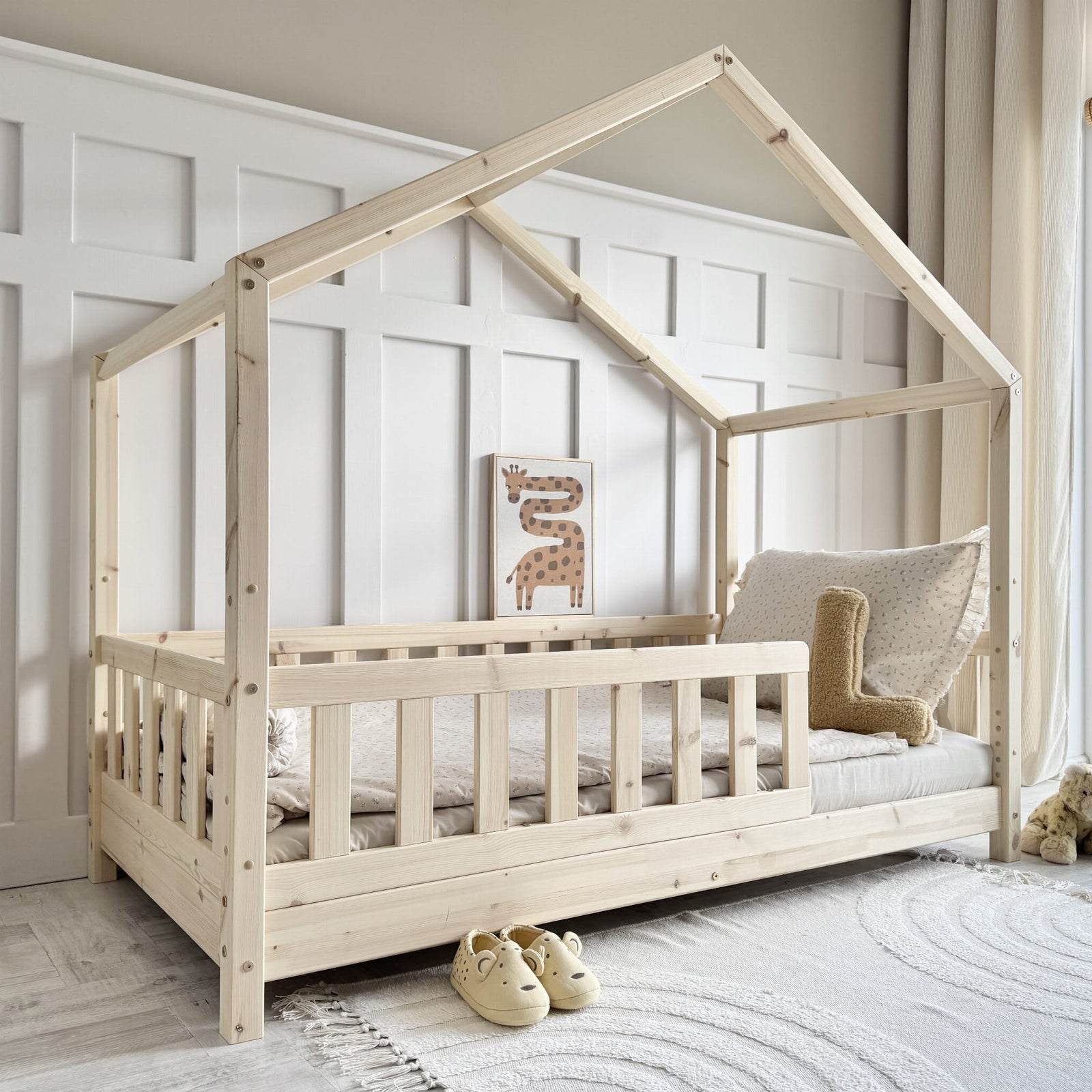natural pine wood house shaped toddler bed with safety rail in scandi bedroom