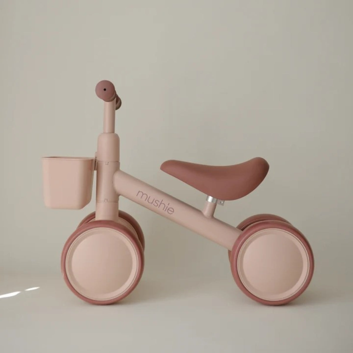 side view of Mushie Mini Toddler Bike in pink Blush