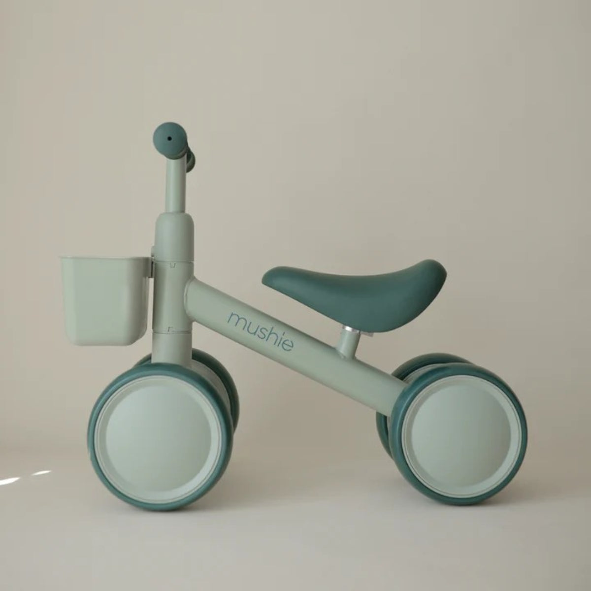 side view of Mushie Mini Toddler Bike in Sage 