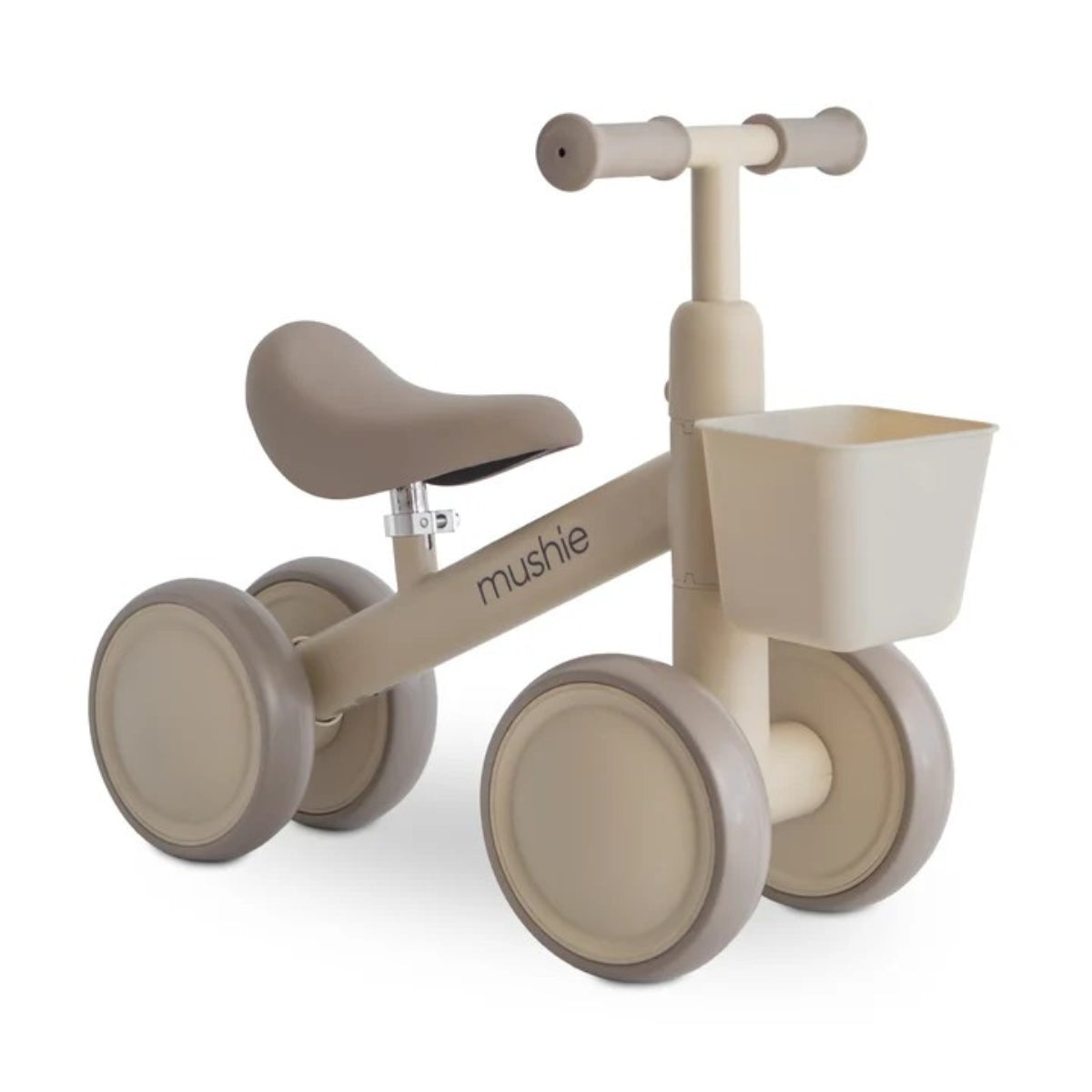 Mushie Mini Toddler Bike in Shifting Sand with EVA wheels, adjustable padded seat and detachable front basket on white background