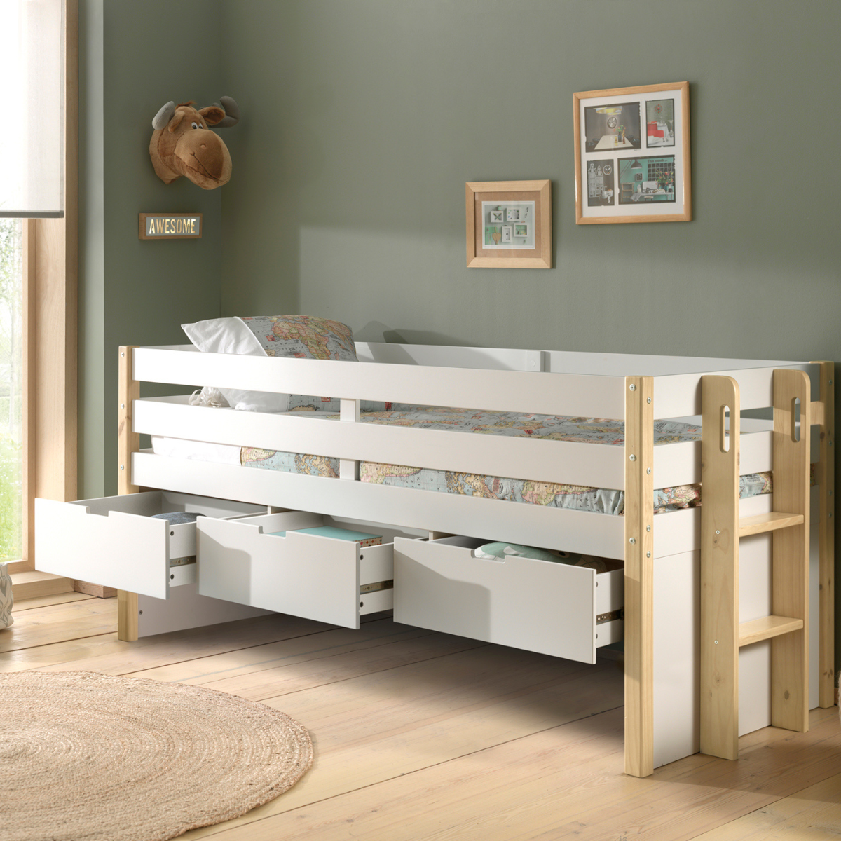 White and natural wooden kids mid sleeper cabin bed. The bed has three underbed storage drawers that have been pulled open and a wooden ladder.