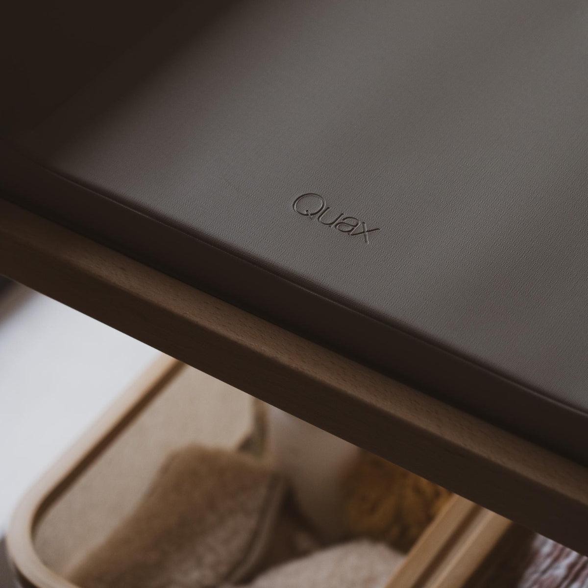 close up of quax logo on changing pad pro thyme