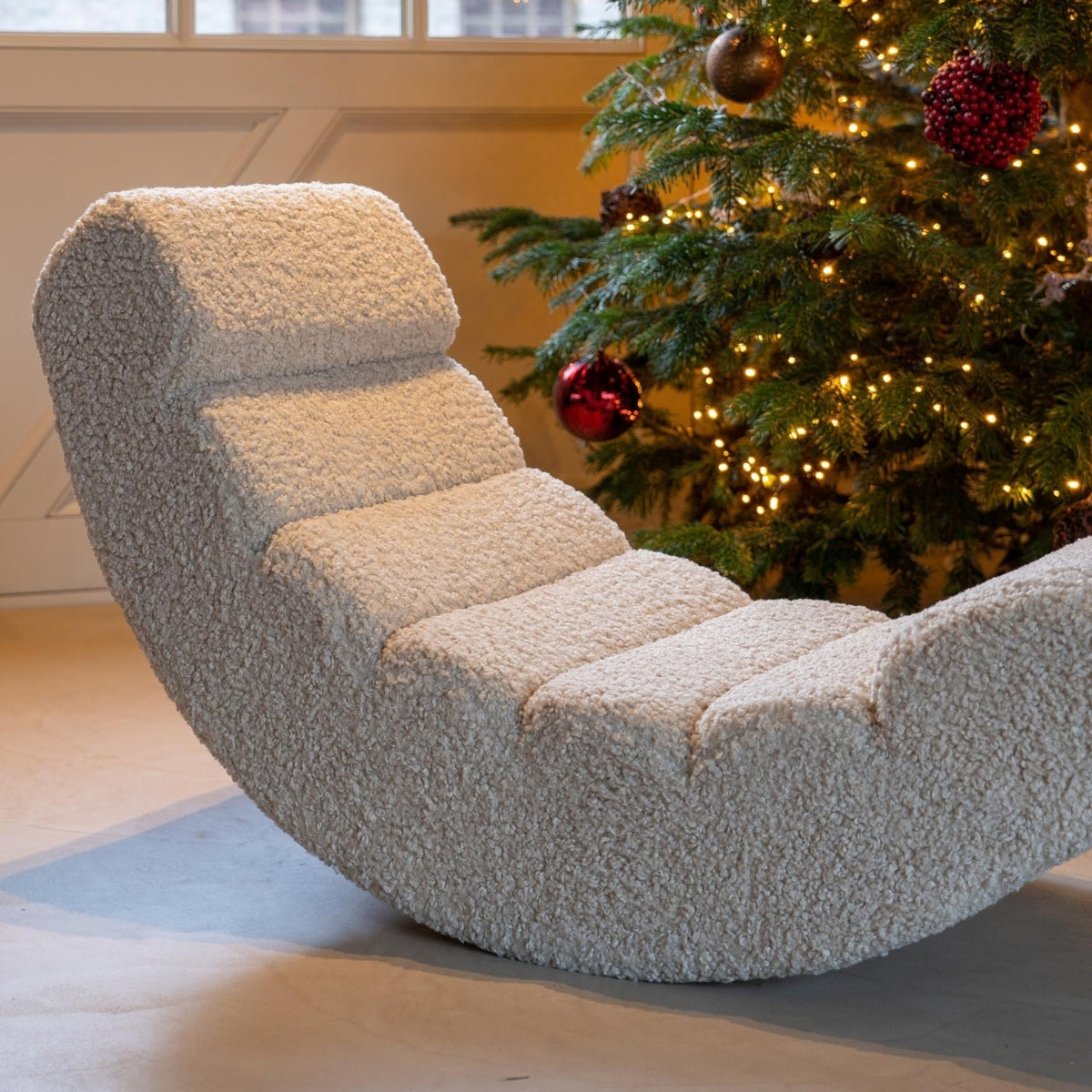 Quax Rocking Banana Sheep upholstered rocking chair in front of christmas tree in contemporary living room