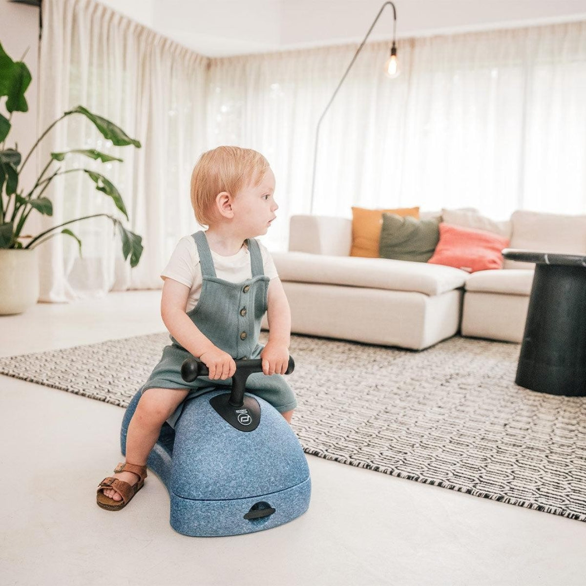 toddler sat on Scoot and Ride My First 3 in 1 Baby Walker Steel in living room