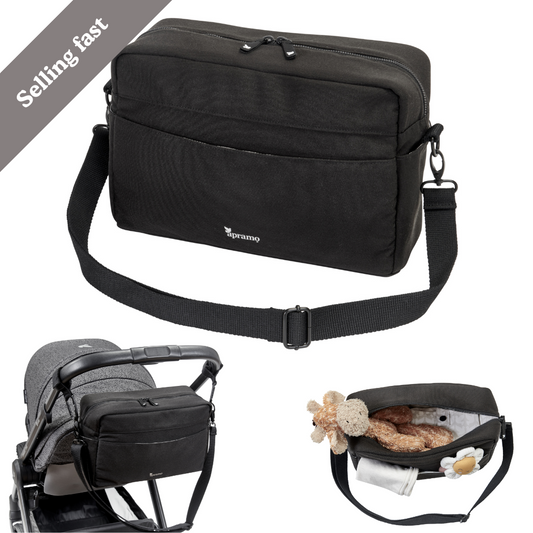 stylish looking black stroller pram puschair organiser bag with shoulder strap made from 100% recycled fabric.  Bag has a storng looking shoulder strap so it can be either be worn by parent or attached to pram or stroller