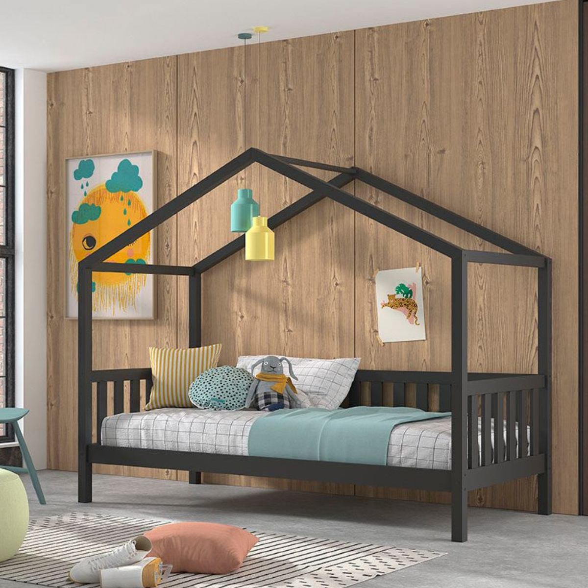 Children's bedroom with a dark grey house-shaped bed against a wooden wall.