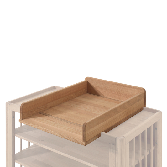 removable oak wood baby changing top fitted on to oak wood changing unit on plain white background