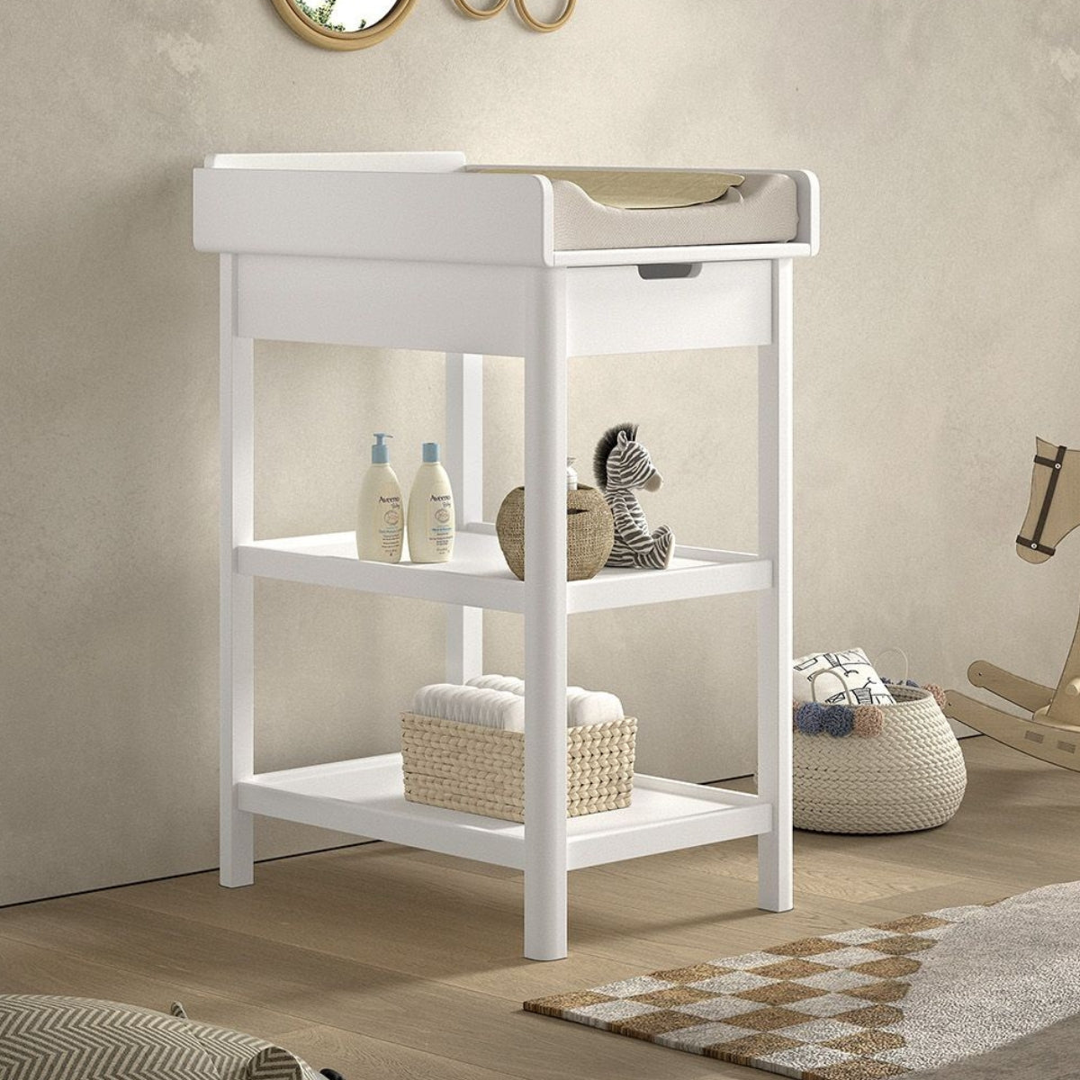 white solid wood baby changing table with a drawer and two shelves in modern nursery