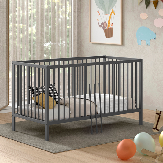 Modern grey coloured wooden 140x70cm cot bed in a modern nursery baby bedroom. FSC certified European beech wooden baby cot. Modern design sturdy looking well built baby cot bed 