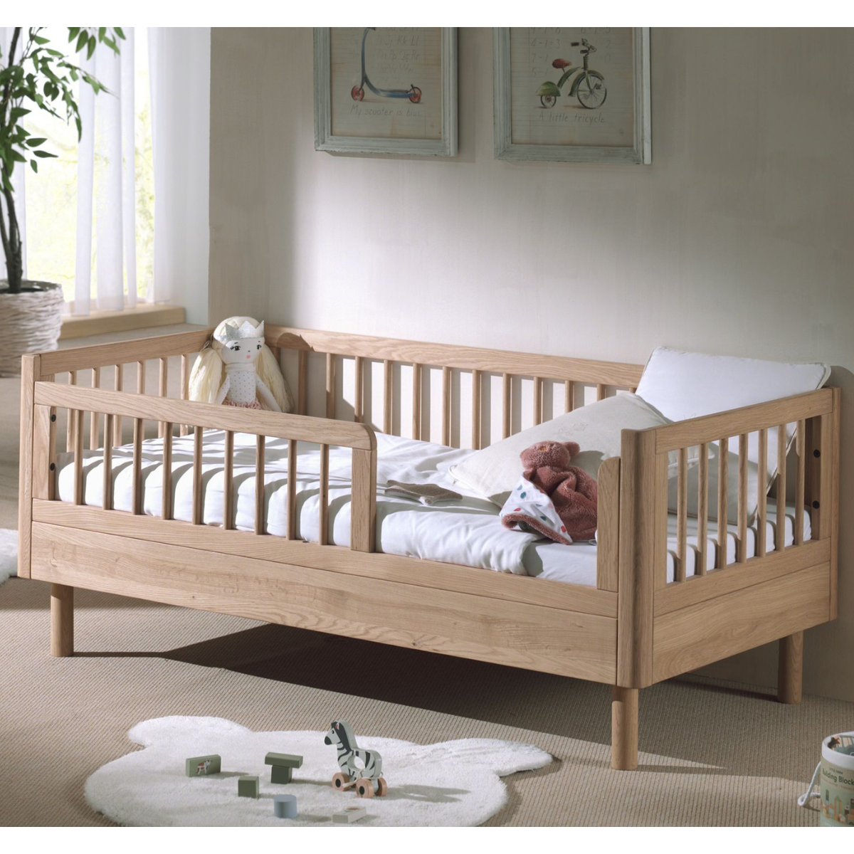 Wooden oak toddler bed in modern nursery toddler room well built sturdy and strong looking wooden toddler bed