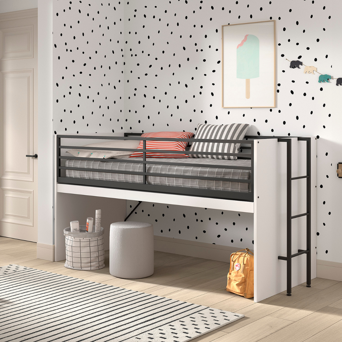 A modern children’s bedroom featuring a VIPACK SAM mid sleeper cabin bed that has an extendable wooden desk underneath that has been folded away. The space underneath the bed is being as a space to store items. The bed has a white finish with black metal railings and ladder. 
