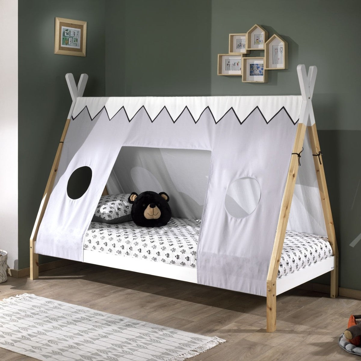 Children's VIPACK teepee bed with white canopy and wooden frame in a room with framed pictures on the wall.