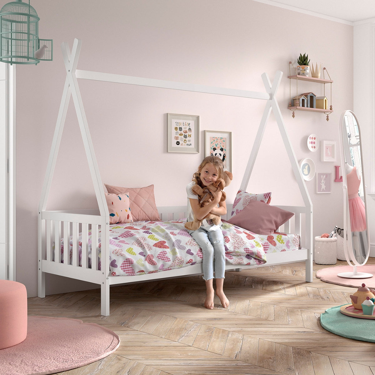girl sat on white VIPACK teepee bed in her bedroom cuddling a teddy bear 