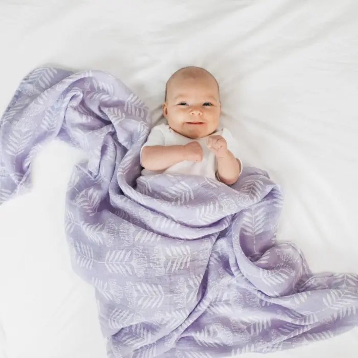 baby wrapped in purple aden + anais Essentials Cotton Muslin Swaddle Blanket Damsel.