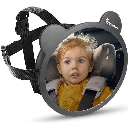 A black rear facing back seat car mirror with adjustable strap reflecting an image of a child in the car seat. 