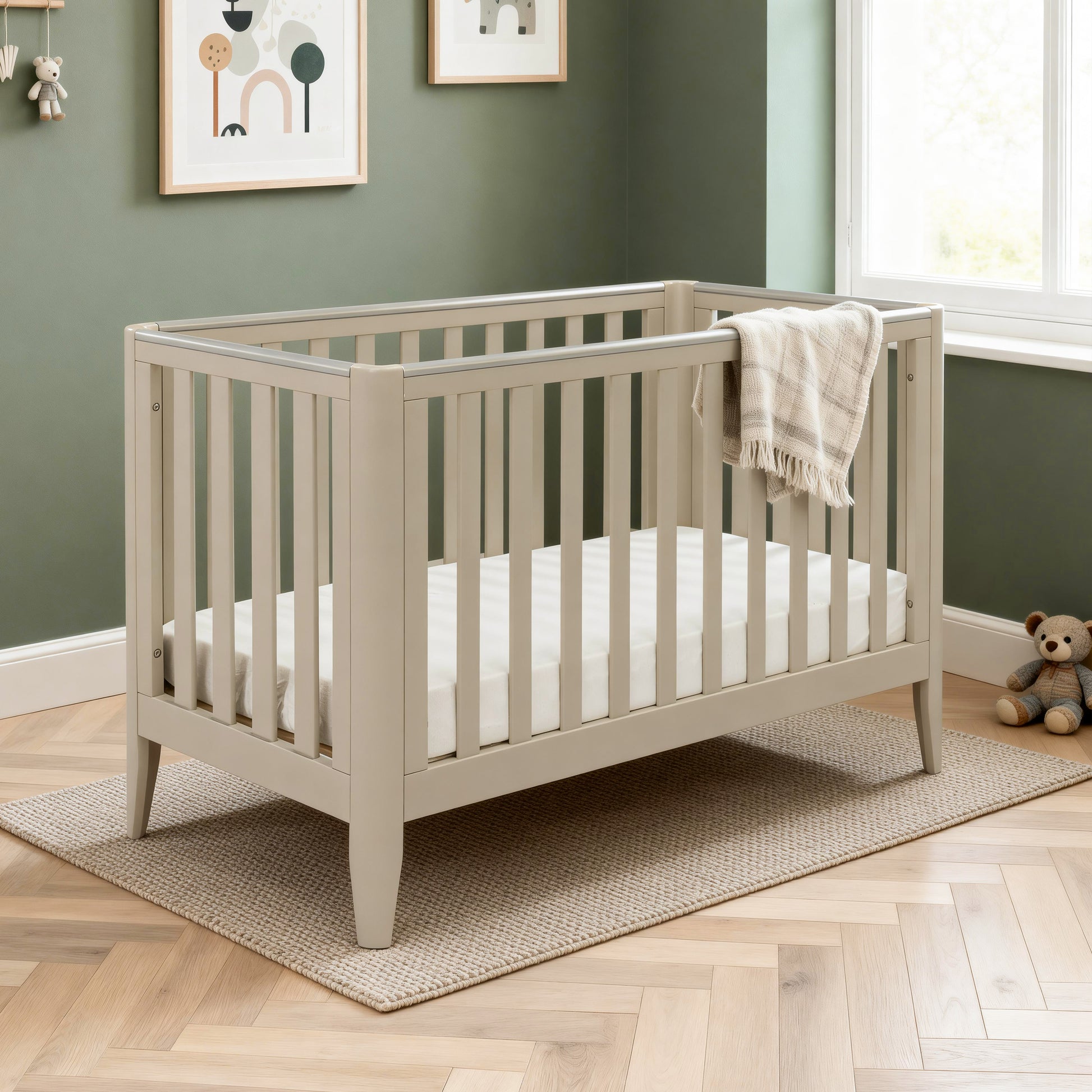 Babymore Iris cot bed cashmere with teething rails in modern nursery bedroom