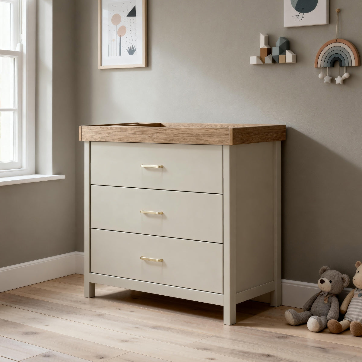 Babymore Mira three drawer nursery chest in Cashmere and Warm Oak styled in a neutral baby nursery