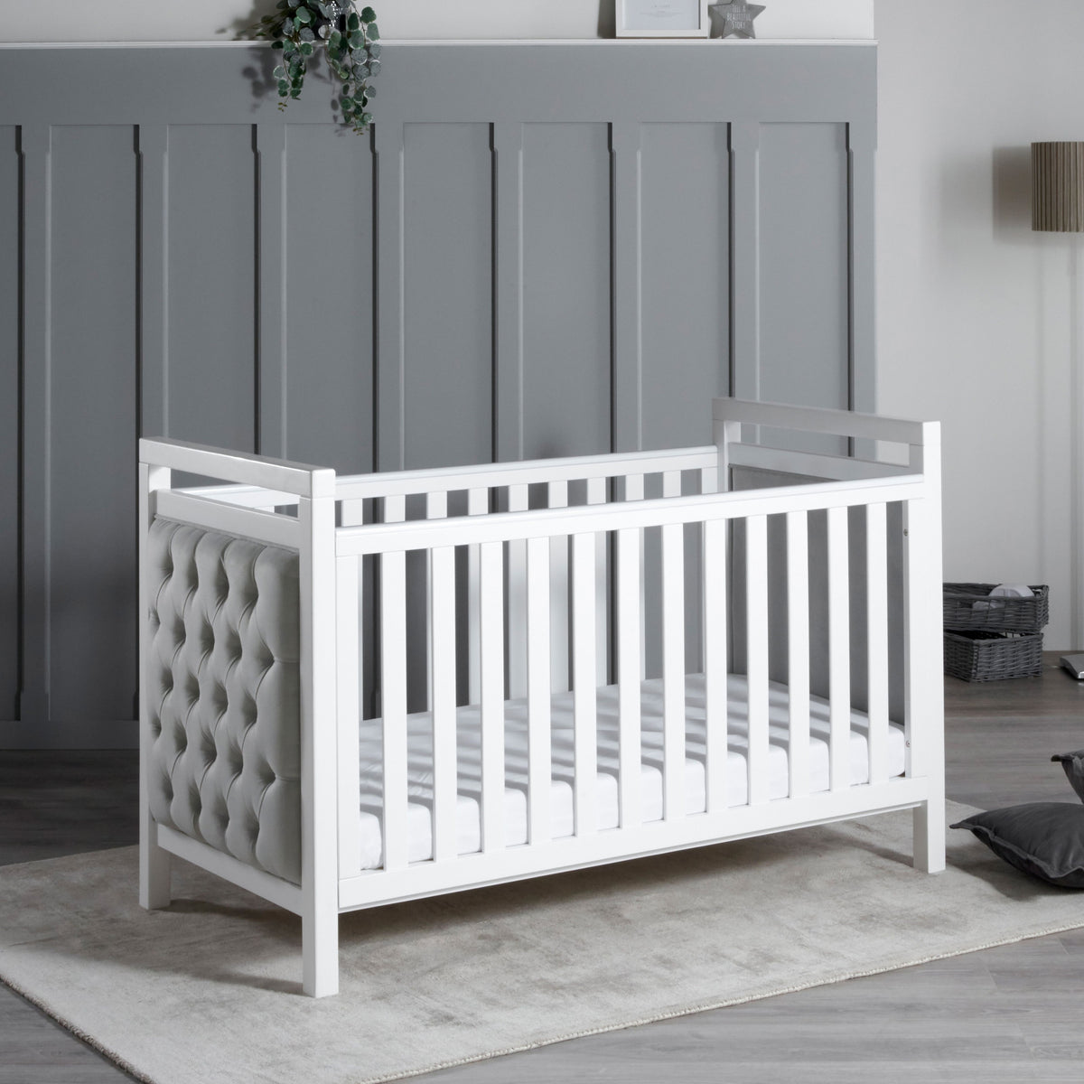 Angled view of Babymore Velvet Deluxe white cot bed for nursery