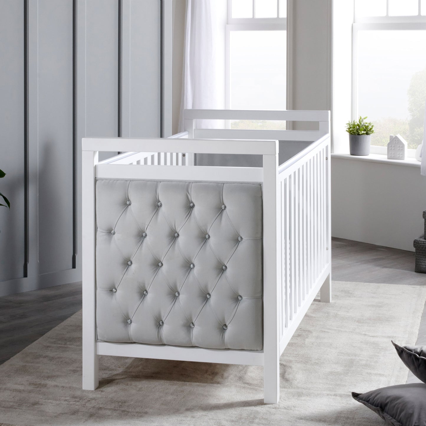 Babymore Velvet Deluxe cot bed in white with upholstered velvet headboard in nursery