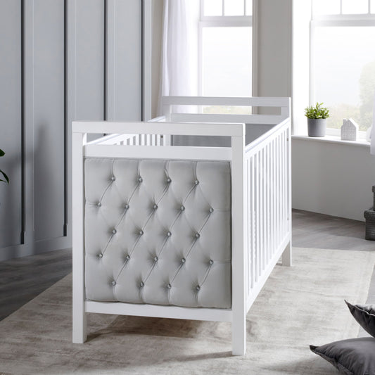 Babymore Velvet Deluxe cot bed in white with upholstered velvet headboard in nursery
