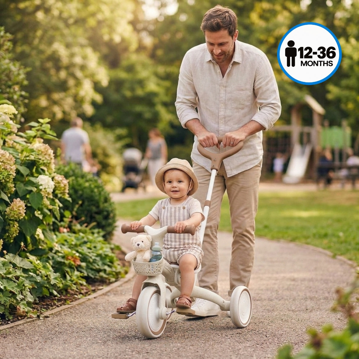 dad pushing a toddler on a Globber Coconut 3-in-1 learning trike in a park
