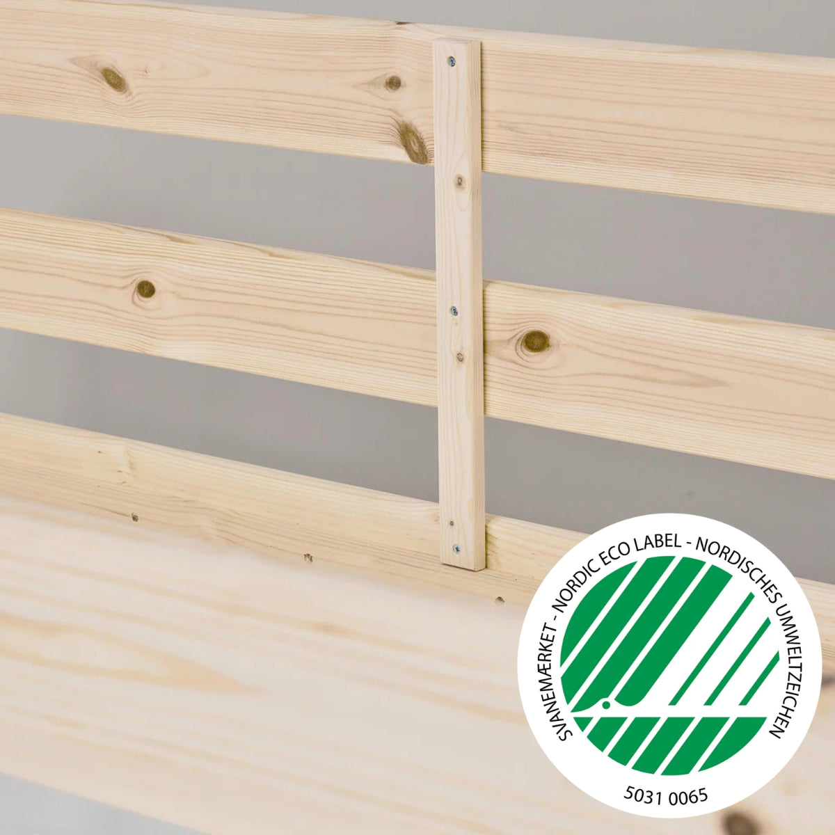 close up view of Hoppekids Eco comfort mid sleeper natural pine wood showing wood grain and nordic eco label