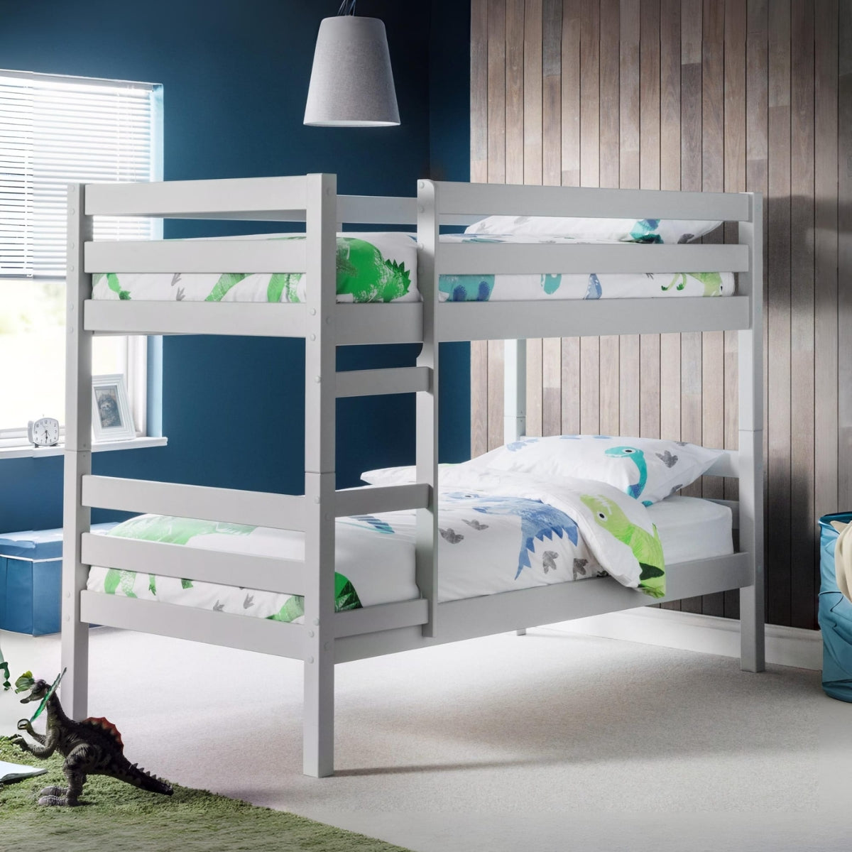 grey bunk bed with dinosaur-themed bedding in a room with blue walls