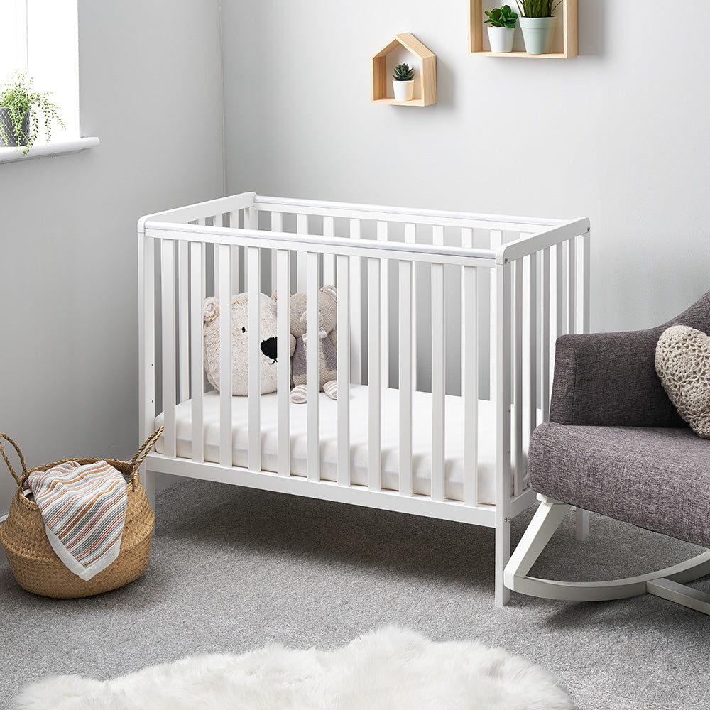 Obaby Bantam Space Saver Cot in white with open slatted sides and adjustable mattress base