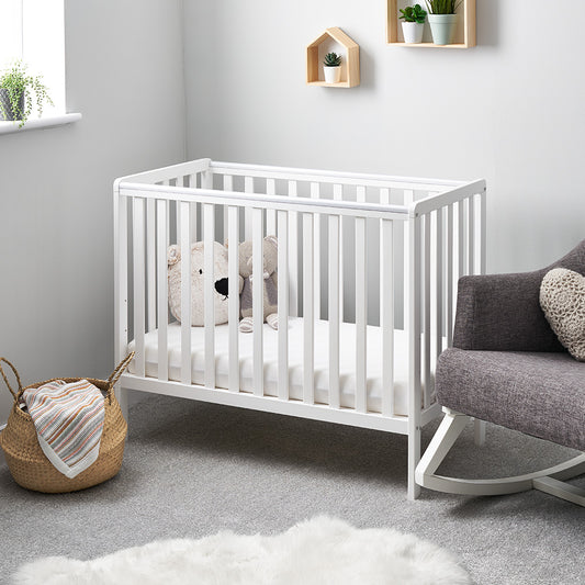 Obaby Bantam Space Saver Cot in white with open slatted sides and adjustable mattress base