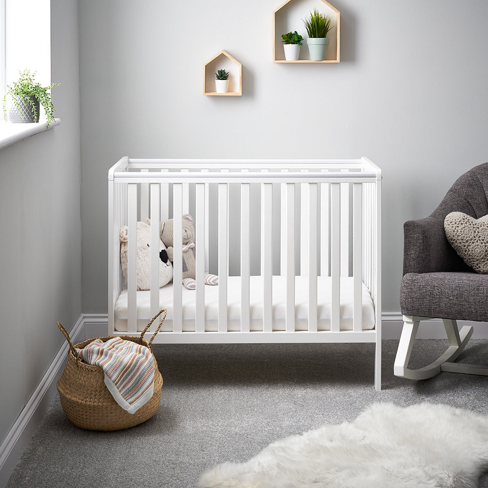 Obaby Bantam Space Saver Cot in white in small baby nursery