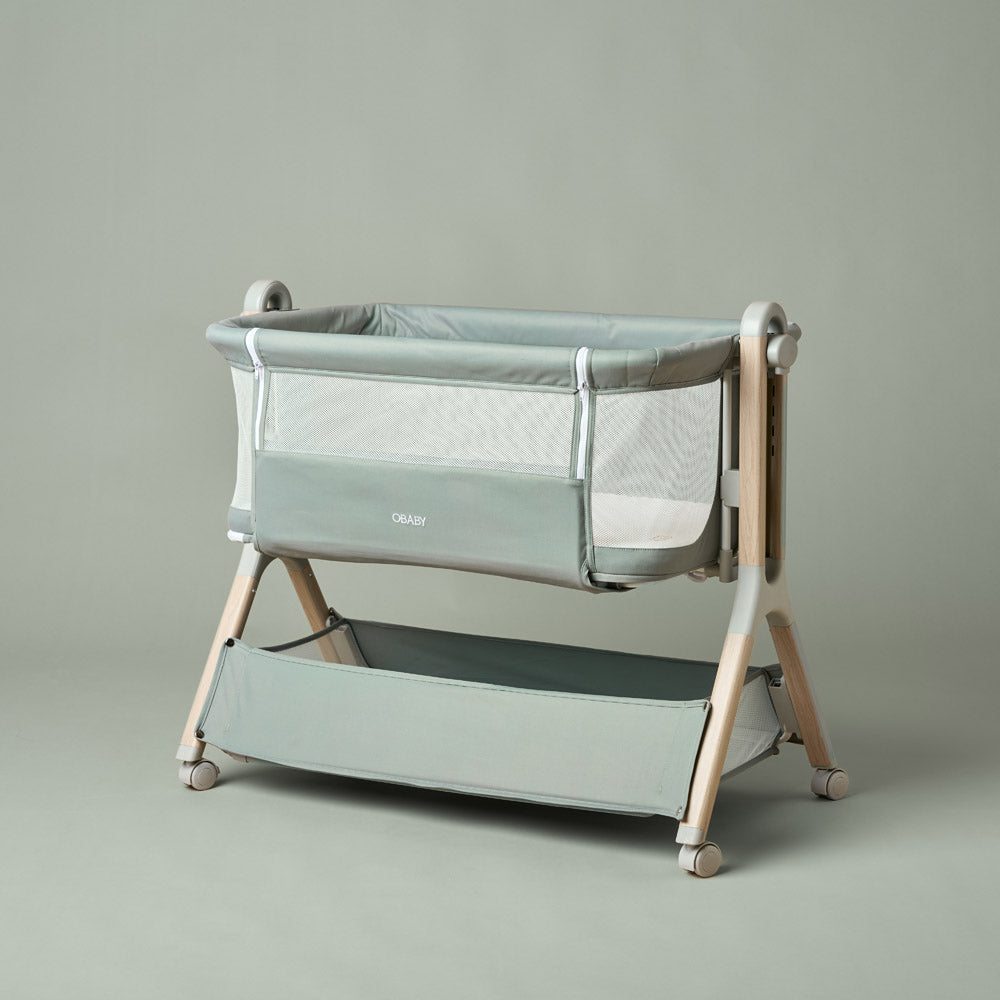Obaby Cloud next to me bedside crib in Sage green with mesh side panels and included 79 × 48cm mattress