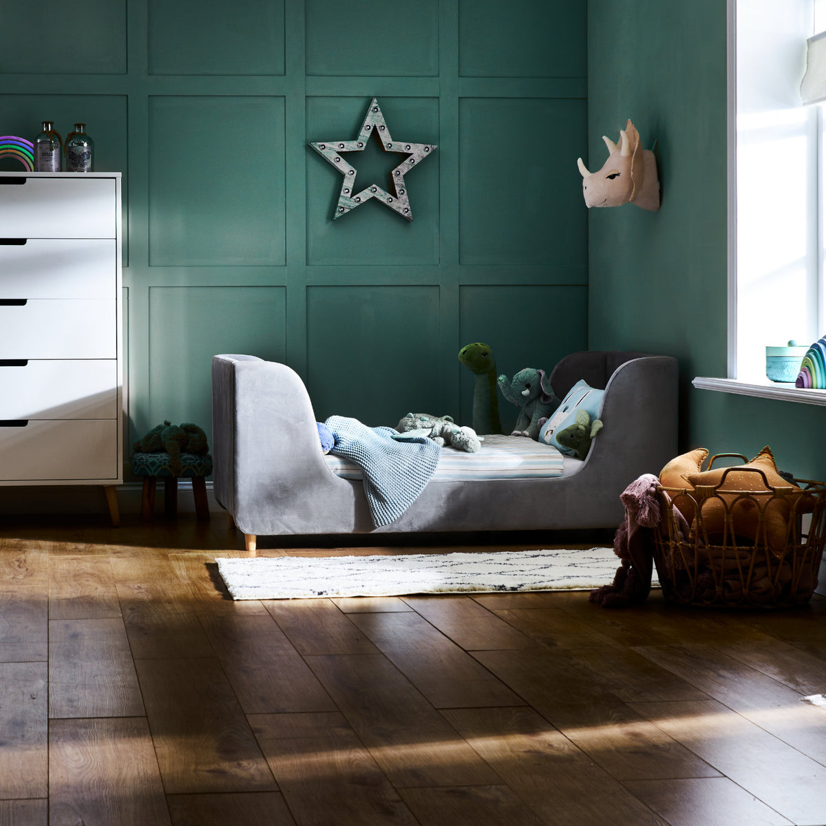 Obaby Lumi Grey velvet toddler bed with a low upholstered frame for a 140 × 70cm mattress in child's bedroom