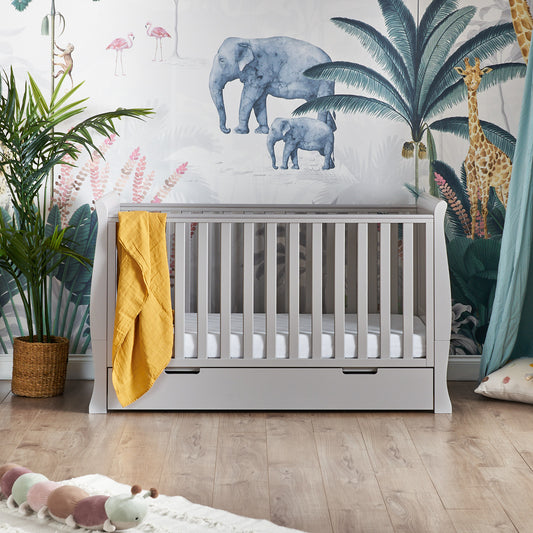 Obaby Stamford Classic sleigh cot bed in warm grey and built in under bed storage drawer in baby nursery