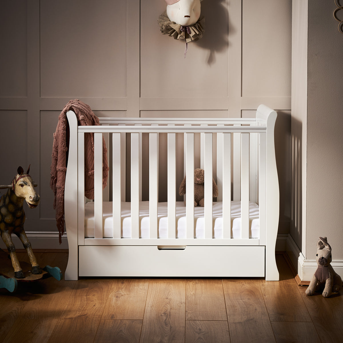 Obaby Stamford white space saver sleigh cot with matching under drawer in small baby nursery