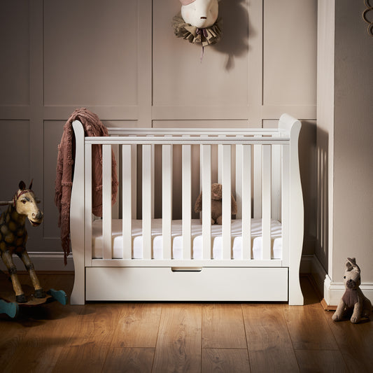 Obaby Stamford white space saver sleigh cot with matching under drawer in small baby nursery