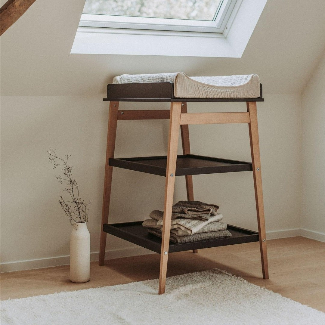 quax hip baby changing table in black and naural wood with comfy changing pad in modern scandi nursery