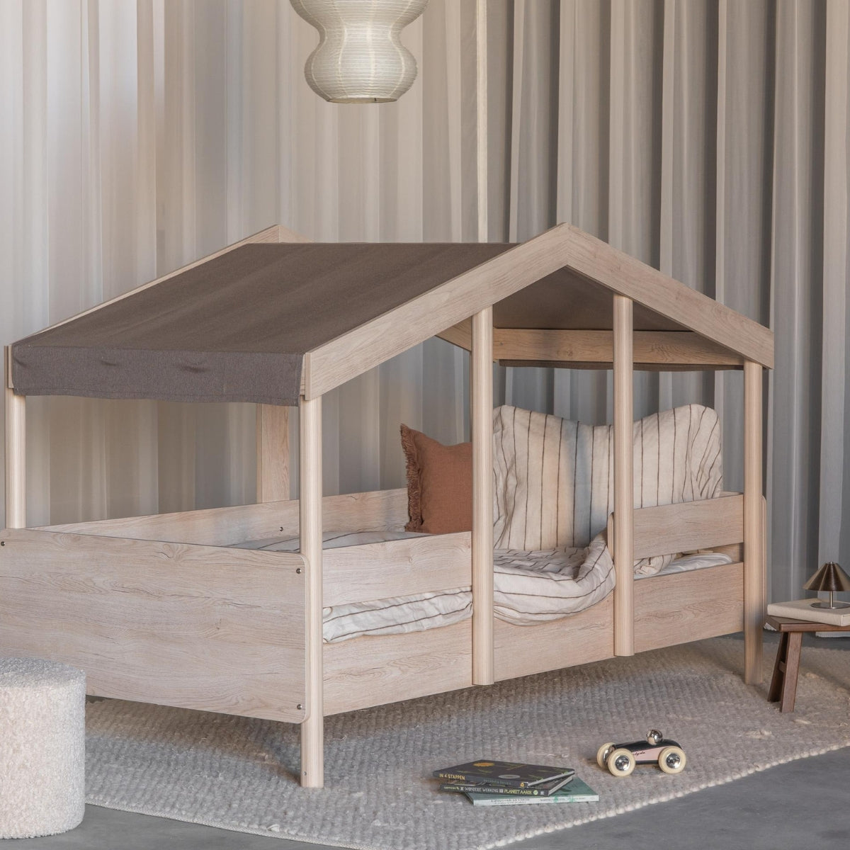 Quax Cottage Montessori House Bed 90 x 200cm on raised legs with Chocolat fabric roof in a child's bedroom
