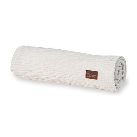 Rolled-up clay Quax 100% cotton muslin baby blanket on a plain white background