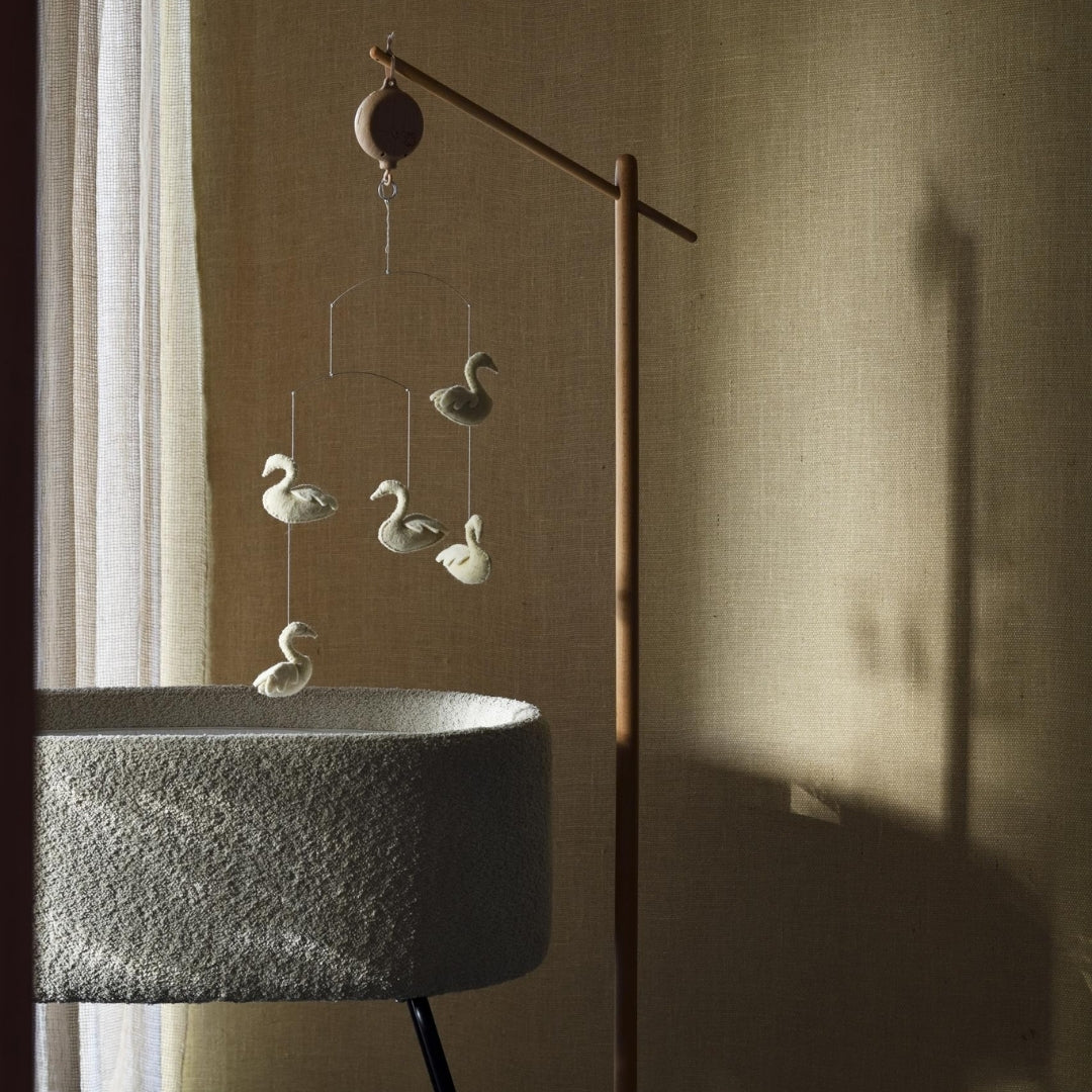 quax swans baby mobile hanging over cradle deluxe in calm baby nursery 