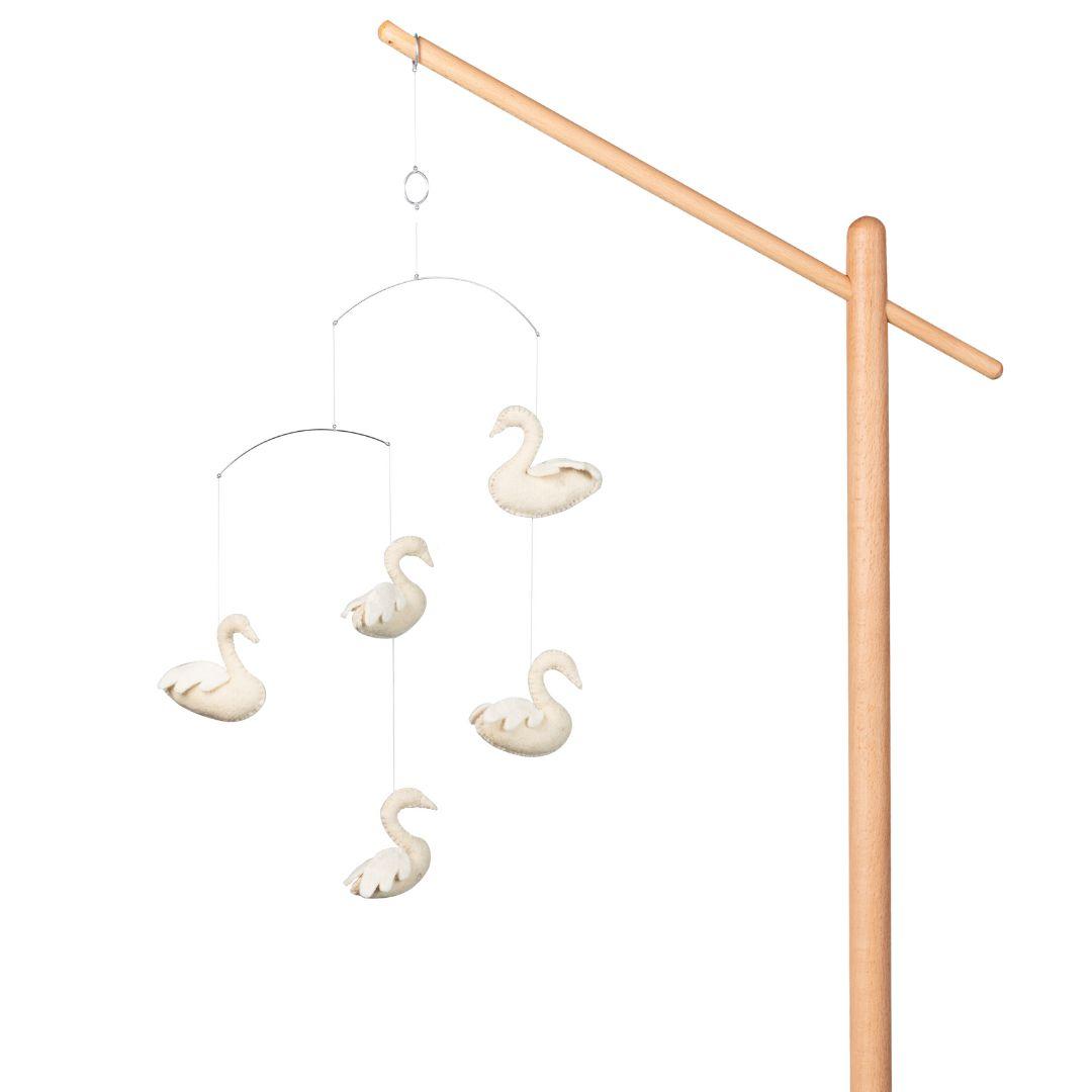 quax swans scandinavian baby mobile hanging from wooden stand on plain white background